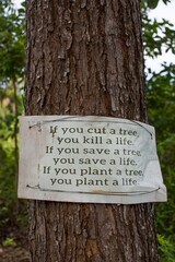 environmental conservation sign on a tree in the forest 