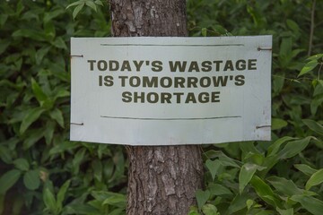 environmental conservation sign on a tree in the forest 