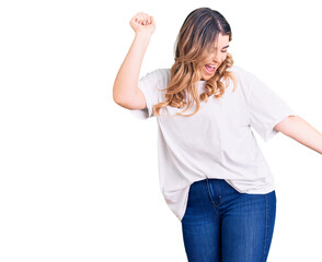 Young caucasian woman wearing casual clothes dancing happy and cheerful, smiling moving casual and confident listening to music