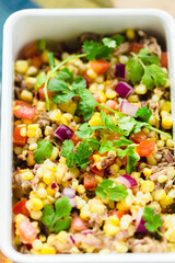 Corn salad with beef, tomatoes , red onion and cilantro