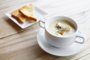 A bowl of soup with toast