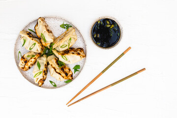 Asian dumplings with soy sauce and chopsticks