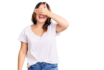 Young beautiful caucasian woman wearing casual white tshirt smiling and laughing with hand on face covering eyes for surprise. blind concept.