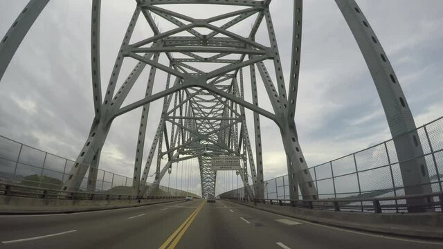 PANAMA CITY, PANAMA - JUNE 20, 2020: POV of road traffic on the bridge of the Americas entrance to the Panama Canal in the west of Panama city.