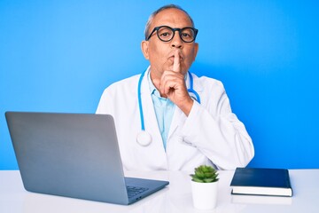Senior handsome man with gray hair wearing doctor uniform working using computer laptop asking to...