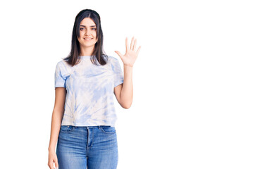 Obraz premium Young beautiful girl wearing casual t shirt showing and pointing up with fingers number five while smiling confident and happy.