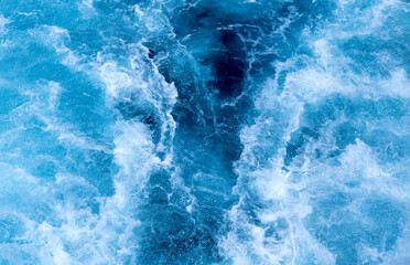 Ship trail on sea water top view photo. White foam on blue water. Ocean transportation. Tropical...