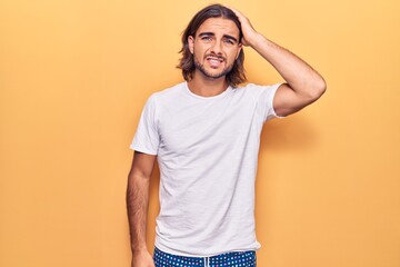 Young handsome man wearing casual clothes confuse and wonder about question. uncertain with doubt,...