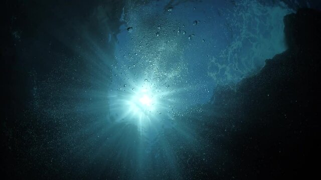 sun ray and sun beam scenery underwater waves on surface of water slow ocean scenery
