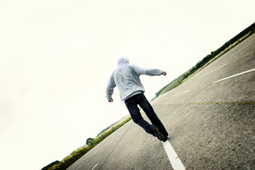 Back shot of a boy trying to walk in a straight line