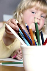 Girl choosing coloured pencils