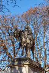 Fototapeta na wymiar Statue of Louis XIII, King of France, on a horse, by Jean-Pierre Cortot (1787-1843) - Place des Vosges in autumn, Paris, France