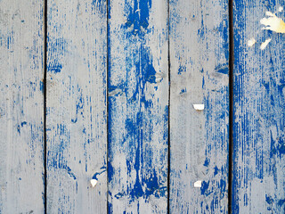 Shabby wooden planks with cracked blue colored old paint