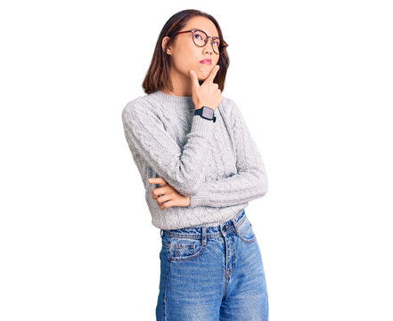 Young beautiful chinese girl wearing casual clothes thinking worried about a question, concerned and nervous with hand on chin