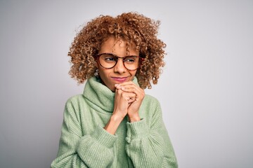 Young beautiful african american woman wearing turtleneck sweater and glasses laughing nervous and...