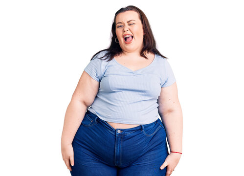 Young plus size woman wearing casual clothes winking looking at the camera with sexy expression, cheerful and happy face.