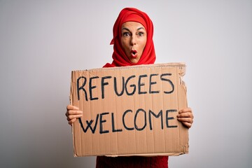Woman wearing muslim hijab asking for immigration holding welcome refugees message scared in shock...