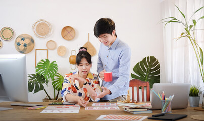 Concept business working and people happy businesses creative female office worker with computers writing to notebook with documents and laptop.