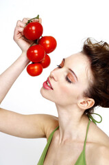 Woman holding a bunch of tomatoes