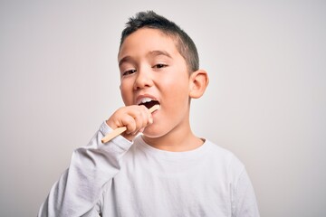 Young little kid boy brushing her teeth using tooth brush and oral paste, cleaning teeth and tongue as healthy health care morning routine. Learning dental education