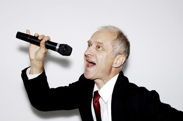 Naklejka premium Businessman belting out a song