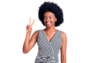 Young african american woman wearing casual clothes showing and pointing up with fingers number two while smiling confident and happy.