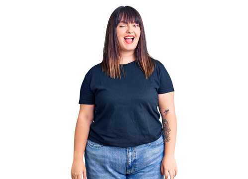 Young plus size woman wearing casual clothes winking looking at the camera with sexy expression, cheerful and happy face.