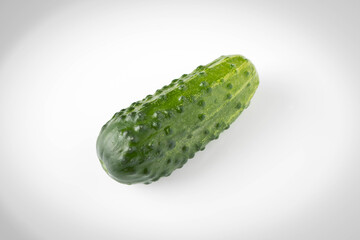 Fresh green cucumber on a light background. The concept of natural food. Selective focus.