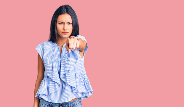 Young beautiful latin girl wearing casual clothes pointing displeased and frustrated to the camera, angry and furious with you