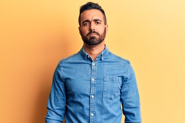 Obraz premium Young hispanic man wearing casual clothes depressed and worry for distress, crying angry and afraid. sad expression.