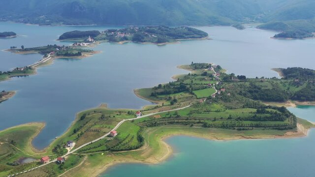 Rama Lake in Bosnia and Herzegovina with peninsula islands below, Aerial pedestal lift shot wide view