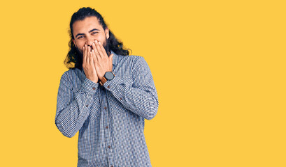 Young arab man wearing casual clothes laughing and embarrassed giggle covering mouth with hands,...