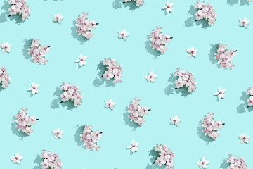 Apple tree floral pattern. Bright summer background. Spring white fruit flowers. Repeat spring texture. Creative trend composition. Many springtime elements. Blue