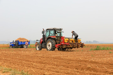 Tractors grow corn in no-tillage operations, Luannan County, Hebei Province, China