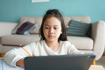 Education. Asian girl is learning with online tutor on tablet digital 