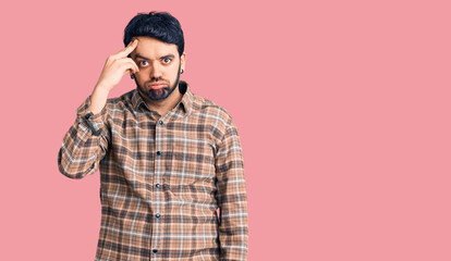 Young hispanic man wearing casual clothes worried and stressed about a problem with hand on forehead, nervous and anxious for crisis