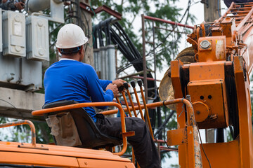 A male employee driving a crane on the job site