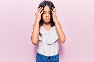 Beautiful child girl wearing casual clothes with hand on head, headache because stress. suffering migraine.