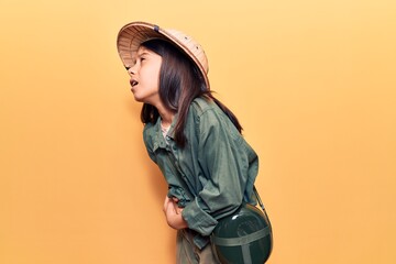 Beautiful child girl wearing explorer hat with hand on stomach because nausea, painful disease...