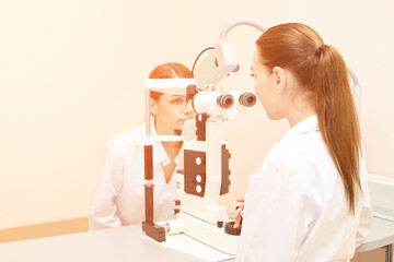 ophthalmologist doctor in exam optician laboratory with female patient. Eye care medical...