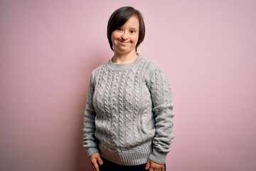 Young down syndrome woman wearing casual sweater over isolated background with a happy and cool smile on face. Lucky person. © Krakenimages.com