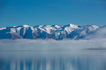 Panorama of Snow Mountain Range Landscape with Blue Sky background from New Zealand.