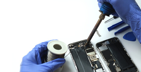 Technician repairing the Cell phone parts and tools for recovery repair phone smartphone and...