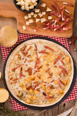 Tart with fried potato, raclette cheese and smoke flavour bacon.
