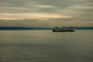 Ferry in Puget Sound in foggy weather and gloomy sunset