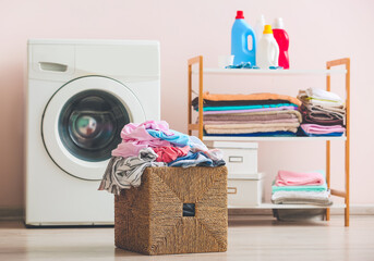 Basket with dirty clothes in home laundry room