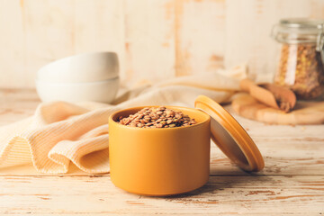 Raw lentils in box on table