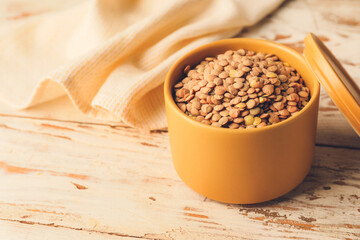 Raw lentils in box on table