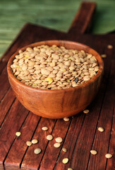 Raw lentils in bowl on table