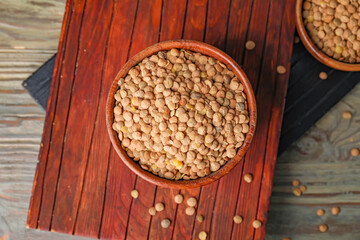 Raw lentils in bowl on table